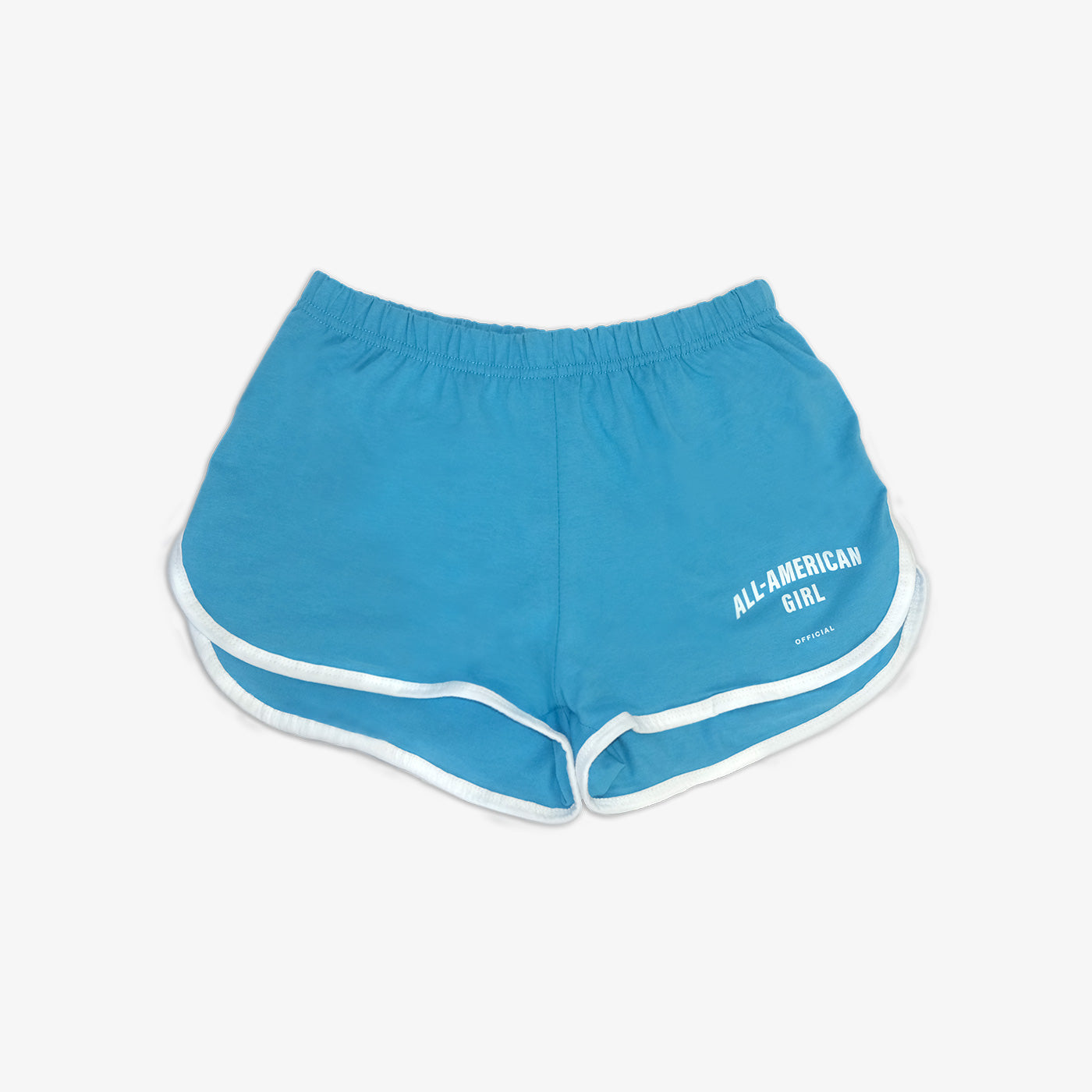 A girl wearing blue All-American Girl track shorts. The shorts say All-American Girl Official on them. This is a comfortable pair of shorts perfect for working out, lounging, or casual style. These shorts come in small, medium, and large.